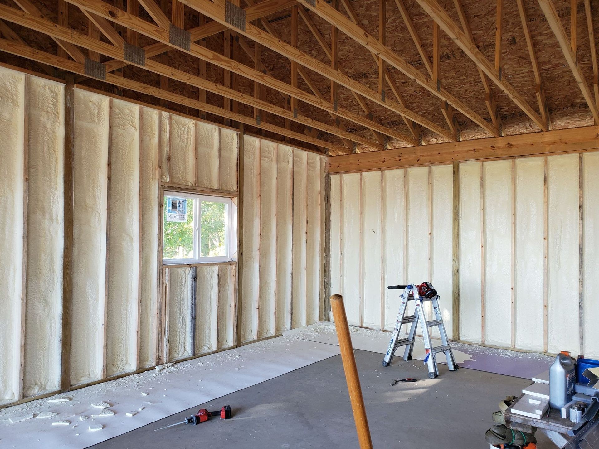 Close-up of residential spray foam insulation installed on interior walls, enhancing home comfort and lowering energy bills in Austin, TX